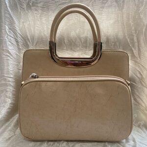 Classic Beige handbag with gold trim hand grip.